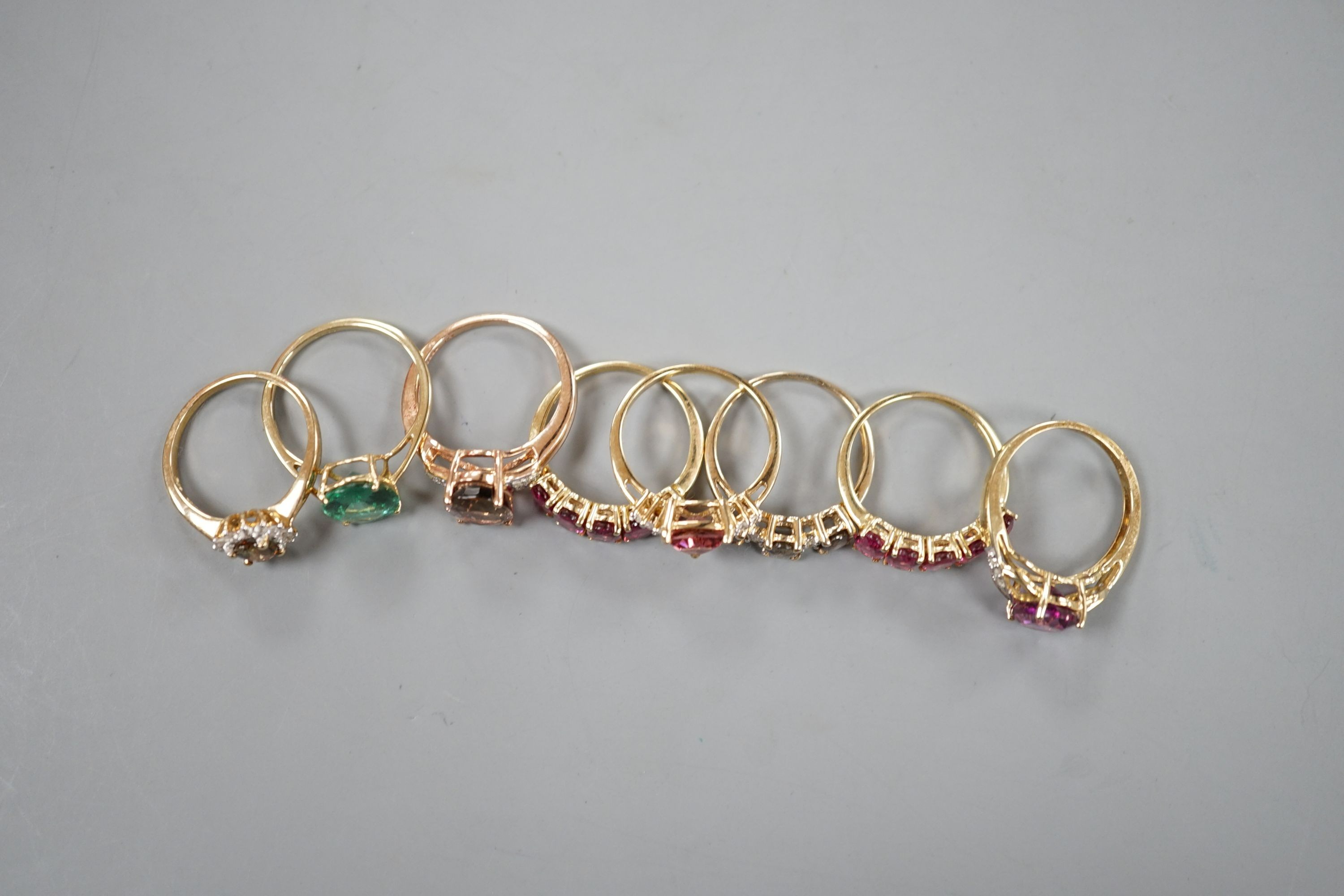 Seven assorted modern 9ct gold and gem set dress rings, including rubellite and a 14ct gold and garnet ring